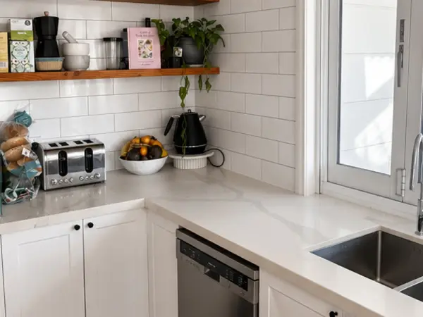 Kitchen after a clean: clear benchtop, wiped splashback and shelves